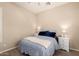 Bedroom showcasing stylish bedding, wood-look flooring and a ceiling fan at 17975 W Agave Rd, Goodyear, AZ 85338