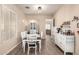 Cozy dining area with wood-look floors, a china cabinet, and a coffee bar at 17975 W Agave Rd, Goodyear, AZ 85338