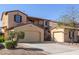 Beautiful stucco home with two garages, wrought iron gate, and low-maintenance landscaping at 17975 W Agave Rd, Goodyear, AZ 85338