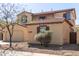 Charming stucco home with a two-car garage, tile roof, and desert landscaping at 17975 W Agave Rd, Goodyear, AZ 85338