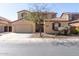 Charming stucco home with a two-car garage, tile roof, and desert landscaping at 17975 W Agave Rd, Goodyear, AZ 85338