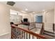 Open hallway view with wood railing, showing the Gathering room with ceiling fan and an adjacent room at 17975 W Agave Rd, Goodyear, AZ 85338