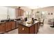 Kitchen showcasing granite countertops, wood cabinets, stainless steel appliances, and wood-look tile flooring at 17975 W Agave Rd, Goodyear, AZ 85338