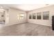 Bright and airy living room with wood-look tile flooring and large windows at 17975 W Agave Rd, Goodyear, AZ 85338