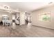 Spacious living area featuring wood-look tile, a dining area, and an open floorplan at 17975 W Agave Rd, Goodyear, AZ 85338