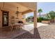 Covered patio area with outdoor seating, a ceiling fan, and views of the landscaped backyard at 17975 W Agave Rd, Goodyear, AZ 85338