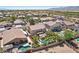 Suburban home featuring a backyard with a sparkling pool, a shaded gazebo, and mature landscaping at 18504 W Maui Ln, Surprise, AZ 85388