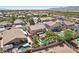 Suburban home featuring a backyard with a sparkling pool, a shaded gazebo, and mature landscaping at 18504 W Maui Ln, Surprise, AZ 85388