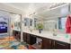 Bathroom with double sinks, a glass shower, a makeup counter, and colorful rugs at 18504 W Maui Ln, Surprise, AZ 85388