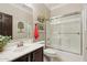 Cozy bathroom with a shower/tub combo, dark wood vanity and neutral paint at 18504 W Maui Ln, Surprise, AZ 85388