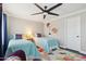 Bright bedroom with hardwood floors, a ceiling fan, and colorful decor at 18504 W Maui Ln, Surprise, AZ 85388