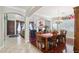 Elegant dining room with wood floors, chandelier, and view into the living room at 18504 W Maui Ln, Surprise, AZ 85388