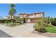 Exterior view of a home featuring mature landscaping, a wide driveway, and a convenient two-car garage at 18504 W Maui Ln, Surprise, AZ 85388