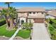 Expansive two-story home featuring a well-manicured lawn, mature landscaping, and a wide driveway leading to a two-car garage at 18504 W Maui Ln, Surprise, AZ 85388