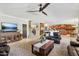 Comfortable living room with ample seating, a stylish rug, and views into the open kitchen at 18504 W Maui Ln, Surprise, AZ 85388