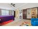 Bright main bedroom featuring an ensuite bathroom, ceiling fan and colorful décor at 18504 W Maui Ln, Surprise, AZ 85388