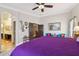 Bright main bedroom featuring an ensuite bathroom, hardwood floor and ceiling fan at 18504 W Maui Ln, Surprise, AZ 85388