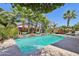 Enjoy a refreshing swim in this pristine pool surrounded by mature palm trees and meticulously manicured landscaping at 18504 W Maui Ln, Surprise, AZ 85388