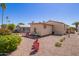 Backyard view featuring decorative furniture, stone landscaping, and well maintained vegetation at 201 S Greenfield Rd # 65, Mesa, AZ 85206