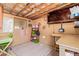 Multi-purpose basement space with exposed ceiling, work table, message board, and decorative rug at 201 S Greenfield Rd # 65, Mesa, AZ 85206