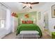 Cozy bedroom featuring a green bedspread, decorative pillows, white dresser, ceiling fan and natural light at 201 S Greenfield Rd # 65, Mesa, AZ 85206