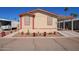 Charming manufactured home featuring desert landscaping and covered parking at 201 S Greenfield Rd # 65, Mesa, AZ 85206