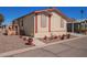 Inviting home with desert landscaping and a cozy front porch at 201 S Greenfield Rd # 65, Mesa, AZ 85206