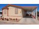 Home with tidy landscaping, carport, and visible unit number for easy identification at 201 S Greenfield Rd # 65, Mesa, AZ 85206