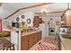 Bright kitchen featuring wooden beams, countertops with copper accents, and a red and white patterned rug at 201 S Greenfield Rd # 65, Mesa, AZ 85206