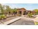 Exterior of the community clubhouse featuring stonework, desert landscaping, and a fountain at 20100 N 78Th Pl # 1013, Scottsdale, AZ 85255