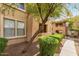 Exterior view of condo building showing gravel landscaping, trees, trimmed bushes, and sidewalks at 20100 N 78Th Pl # 1013, Scottsdale, AZ 85255