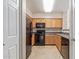 View of the kitchen featuring oak cabinets, black appliances, and tile floors at 20100 N 78Th Pl # 1013, Scottsdale, AZ 85255