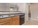 Bright kitchen with stainless steel sink, black dishwasher, and wood cabinets at 20100 N 78Th Pl # 1013, Scottsdale, AZ 85255