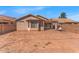 Exterior photo of the back of the house with a dirt yard, patio, porch swing, and block wall at 21655 N Davis Way, Maricopa, AZ 85138