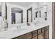 Bright bathroom with dual sinks and a large vanity mirror at 21655 N Davis Way, Maricopa, AZ 85138