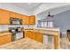 Spacious kitchen featuring stainless steel appliances, wooden cabinets, and laminate countertops at 21655 N Davis Way, Maricopa, AZ 85138