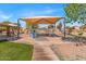 Playground featuring a shade structure over the play equipment with greenery nearby at 21655 N Davis Way, Maricopa, AZ 85138