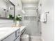 Bright bathroom showcasing a frameless glass shower, gray vanity with quartz countertop, and modern fixtures at 220 W Wood Dr, Chandler, AZ 85248