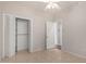 Neutral bedroom featuring bi-fold closet doors, tile floor, and a ceiling fan at 220 W Wood Dr, Chandler, AZ 85248