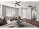 Inviting living room with wood floors, plantation shutters, and stylish furniture, bathed in natural light at 220 W Wood Dr, Chandler, AZ 85248