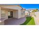 Enjoy this home's charming outdoor patio with ceiling fan, brickwork, and a cozy artificial lawn area at 220 W Wood Dr, Chandler, AZ 85248