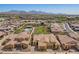 Property aerial view featuring mountain views, lush green spaces, and mature trees enhancing the serene neighborhood setting at 23133 N 73Rd Pl, Scottsdale, AZ 85255