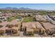 Community aerial view featuring lush green spaces, a pool, and mountain views, showcasing the neighborhood's amenities at 23133 N 73Rd Pl, Scottsdale, AZ 85255