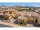 Aerial view of a community with desert landscaping, terracotta roofs, and mountain views in the background at 23133 N 73Rd Pl, Scottsdale, AZ 85255