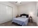 Cozy bedroom featuring plush carpeting, a ceiling fan, and a comfortable bed with a dark headboard at 23133 N 73Rd Pl, Scottsdale, AZ 85255