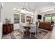 Dining area with a round table, white chairs, and decorative lighting fixture at 23133 N 73Rd Pl, Scottsdale, AZ 85255