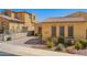 Inviting single-story home featuring desert landscaping, a brick driveway, and a quaint front entryway at 23133 N 73Rd Pl, Scottsdale, AZ 85255