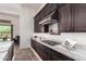 Sleek kitchen with granite countertops, stainless steel appliances, and dark wood cabinets at 23133 N 73Rd Pl, Scottsdale, AZ 85255