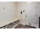 Organized mudroom with a built-in bench, cubbies, hooks, and access to the exterior of the home at 23133 N 73Rd Pl, Scottsdale, AZ 85255