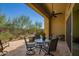 Covered outdoor patio features a ceiling fan, and a landscaped backyard, creating a private and relaxing retreat at 23133 N 73Rd Pl, Scottsdale, AZ 85255